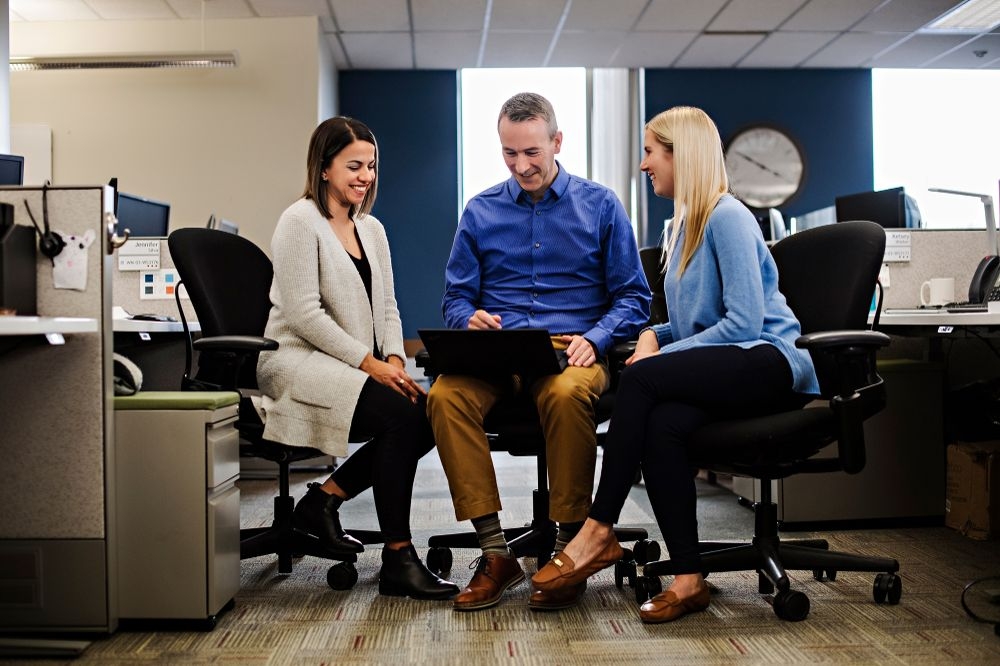 Definity employees collaborating on a digital communication.